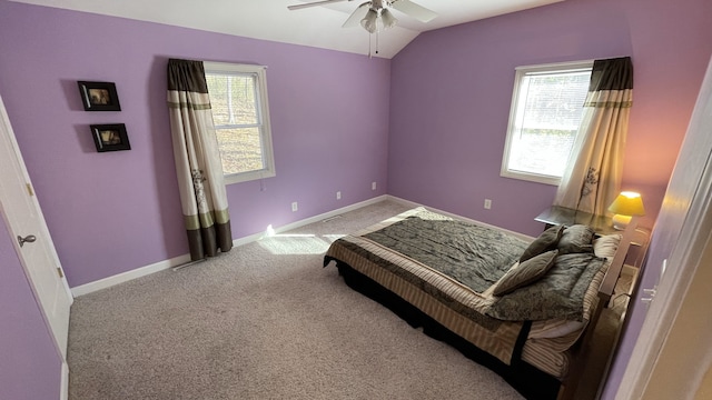 bedroom featuring carpet floors, multiple windows, baseboards, and lofted ceiling