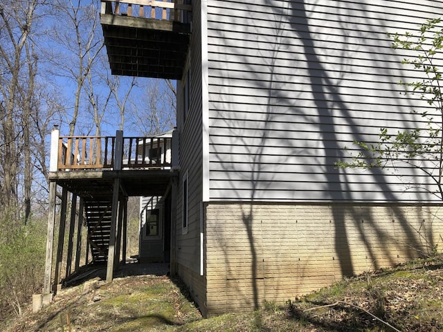 view of home's exterior featuring stairs and a deck