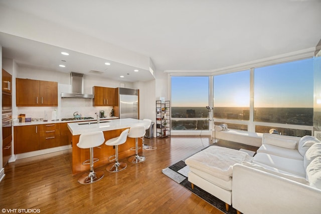 living area with a wall of windows, dark wood finished floors, and recessed lighting