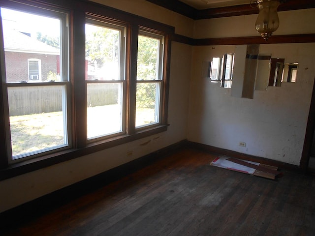 empty room featuring dark wood finished floors and baseboards