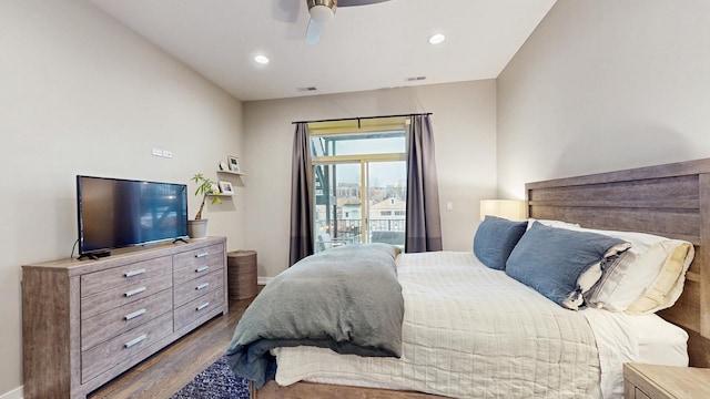 bedroom featuring access to outside, wood finished floors, visible vents, and recessed lighting