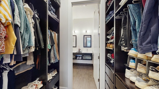 walk in closet with tile patterned flooring