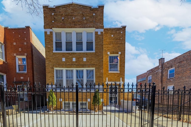 view of front of house featuring brick siding and fence