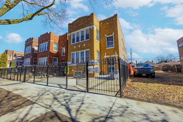 view of front of home featuring brick siding, fence, and a residential view