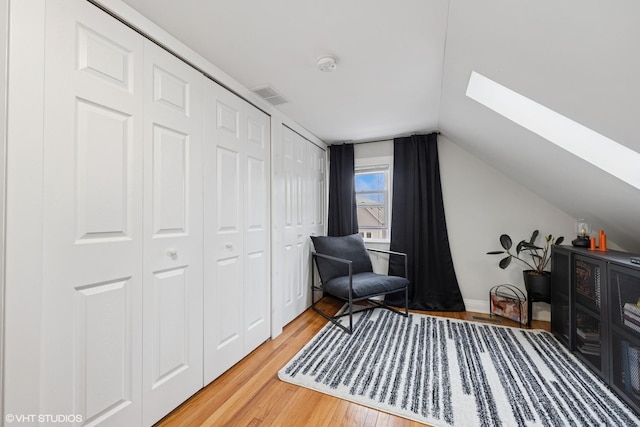 2531 W Lyndale St, Chicago, IL 60647 - living area with a skylight, light wood-style flooring, and vaulted ceiling