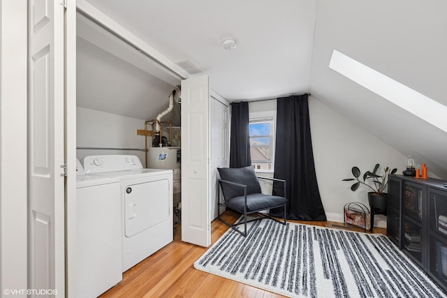 2531 W Lyndale St, Chicago, IL 60647 - laundry room with independent washer and dryer, a skylight, light wood finished floors, and gas water heater