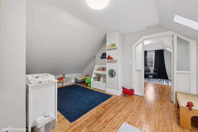 2531 W Lyndale St, Chicago, IL 60647 - game room with vaulted ceiling, light wood finished floors, and a skylight