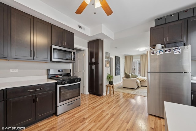 2531 W Lyndale St, Chicago, IL 60647 - kitchen featuring appliances with stainless steel finishes, light countertops, light wood finished floors, ceiling fan, and dark brown cabinets