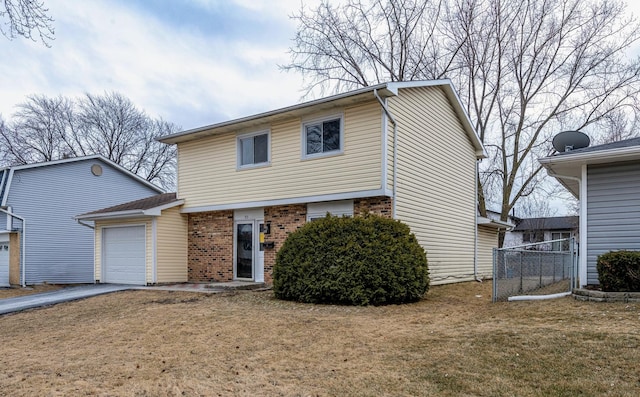 view of front of home with driveway, brick siding, a front lawn, and an attached garage