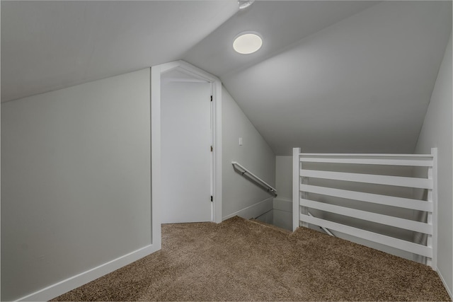 additional living space with lofted ceiling, carpet flooring, and baseboards