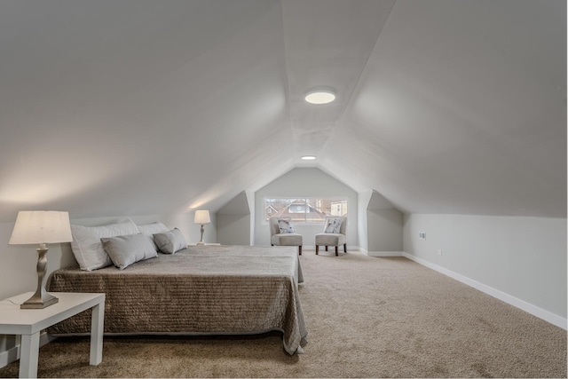 bedroom featuring carpet floors, lofted ceiling, and baseboards