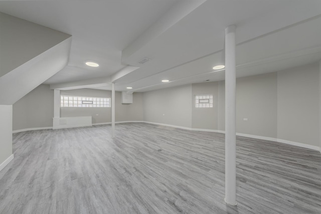 below grade area featuring visible vents, baseboards, wood finished floors, and recessed lighting