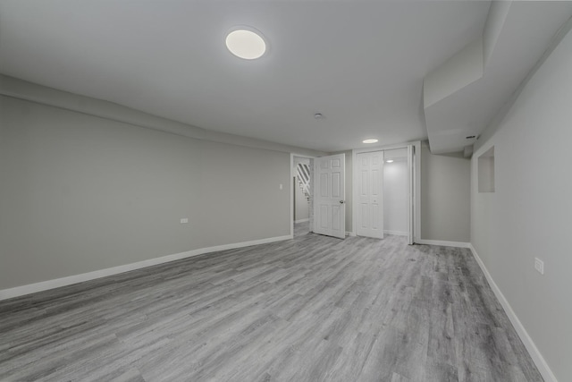 interior space with wood finished floors and baseboards