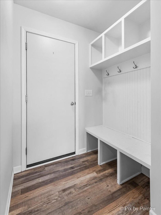 mudroom with dark wood-type flooring and baseboards