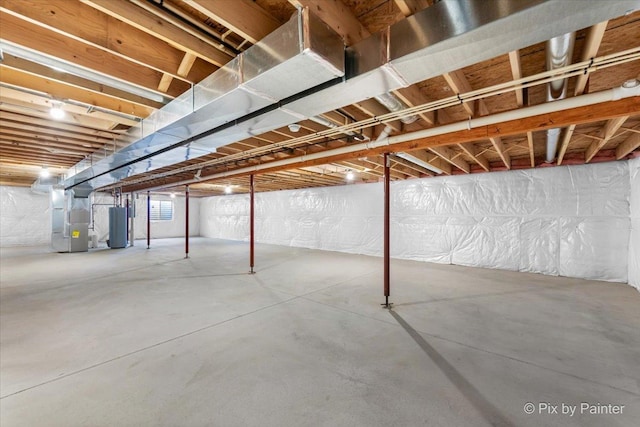 basement featuring heating unit and water heater