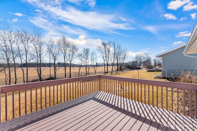 deck with a yard and fence