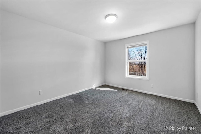 unfurnished room with visible vents, baseboards, and carpet flooring