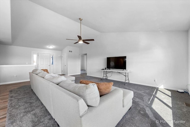 living area with visible vents, baseboards, a ceiling fan, wood finished floors, and vaulted ceiling