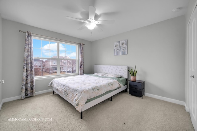 carpeted bedroom with baseboards and a ceiling fan