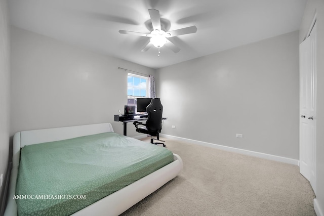 carpeted bedroom with a ceiling fan and baseboards