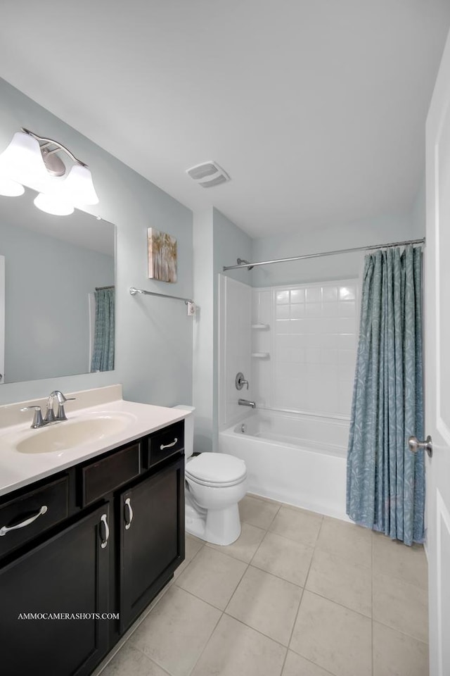 bathroom with toilet, vanity, visible vents, tile patterned floors, and shower / bath combo with shower curtain