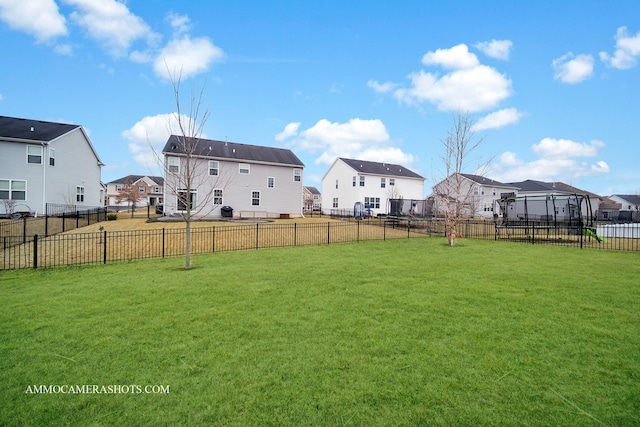 view of yard featuring fence and a residential view