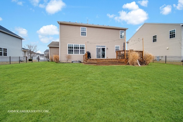 rear view of property with a yard, fence private yard, and a wooden deck