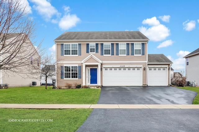 view of front facade featuring aphalt driveway and a front yard