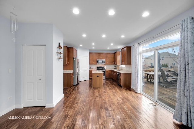 kitchen with dark wood-style floors, appliances with stainless steel finishes, light countertops, and recessed lighting