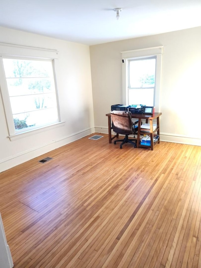 misc room with visible vents, plenty of natural light, and light wood-style flooring