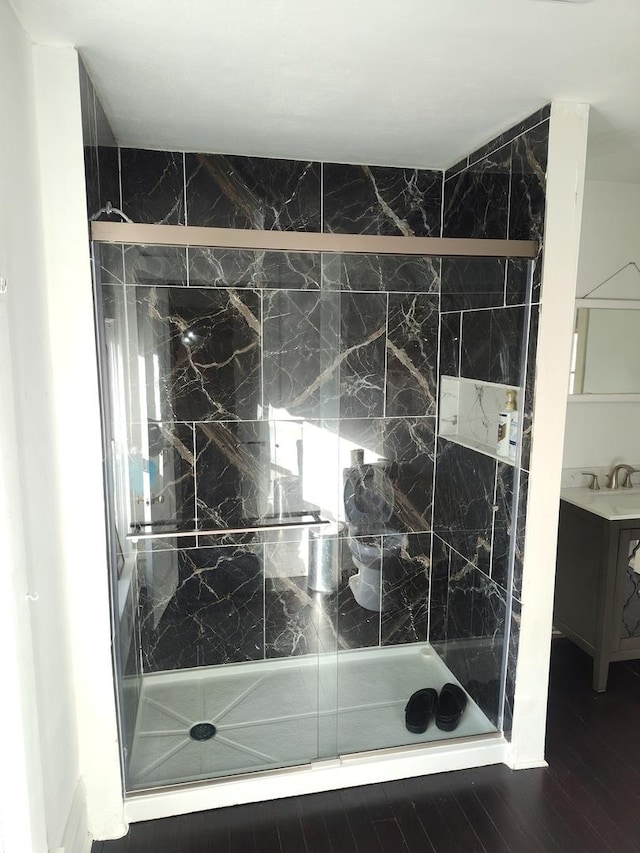 bathroom featuring a stall shower and wood finished floors