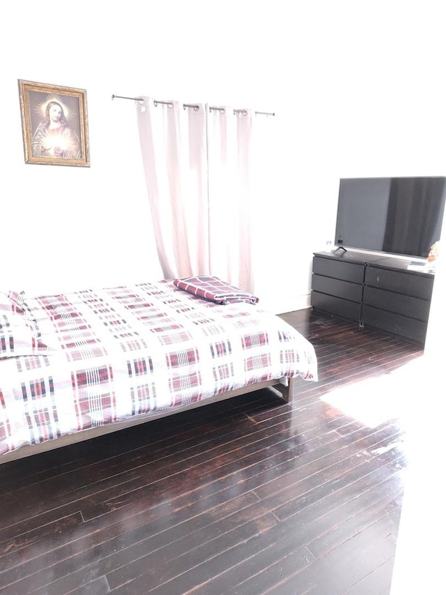 bedroom featuring wood finished floors