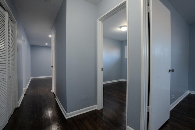 corridor featuring hardwood / wood-style flooring and baseboards