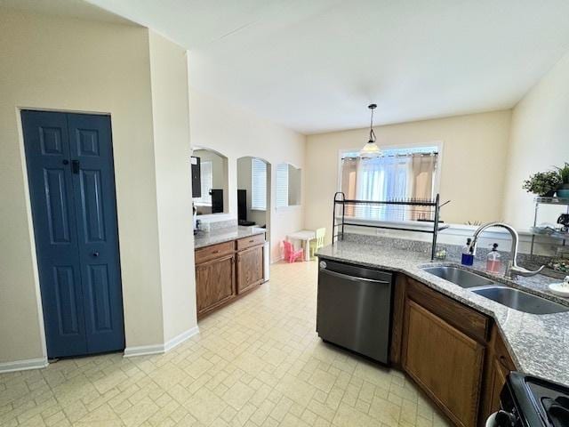 kitchen with arched walkways, range with electric cooktop, a sink, dishwasher, and pendant lighting