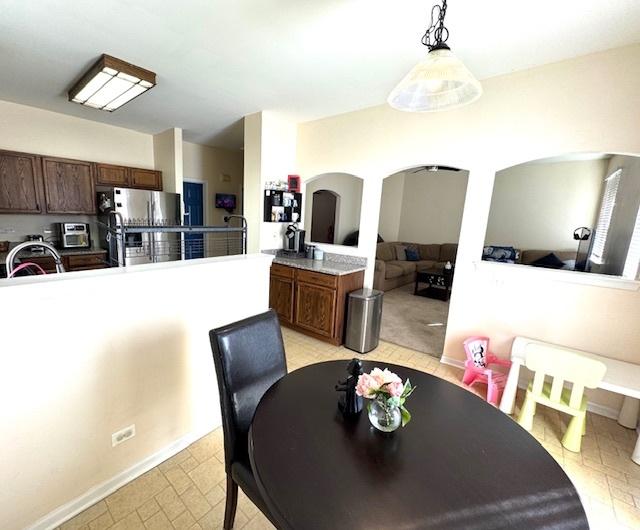 dining space featuring arched walkways