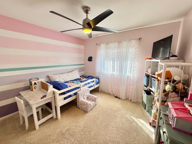 bedroom with carpet and a ceiling fan