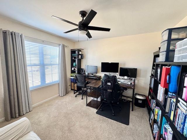 office featuring carpet flooring, ceiling fan, and baseboards