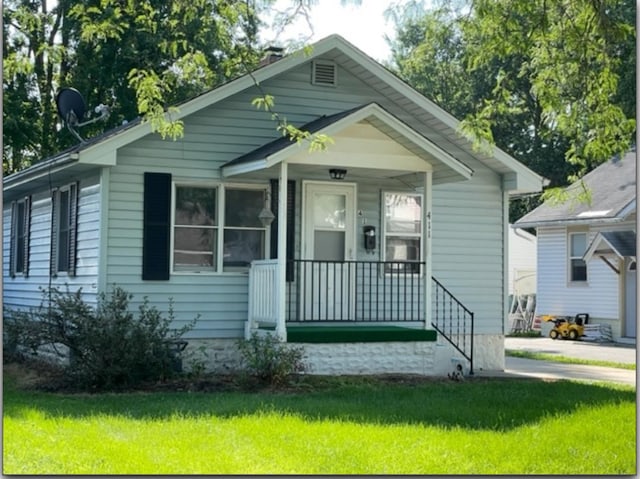 bungalow-style home featuring a porch and a front yard