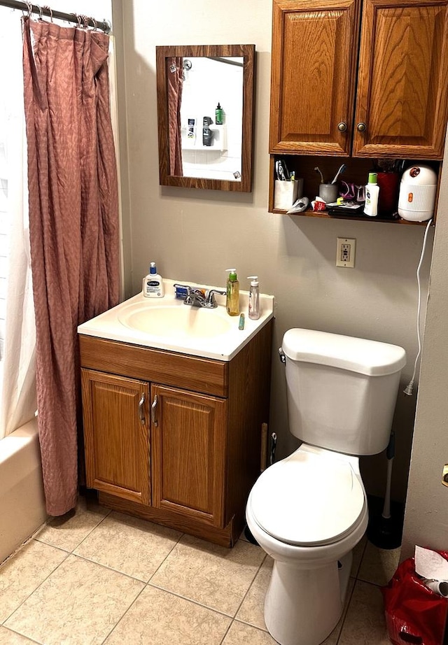 full bathroom featuring tile patterned flooring, vanity, and toilet