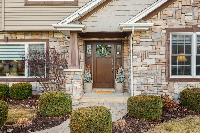 doorway to property with stone siding