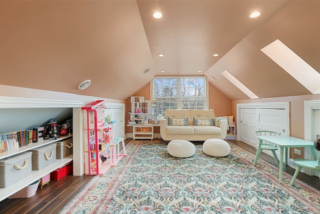 interior space featuring vaulted ceiling with skylight, recessed lighting, and wood finished floors