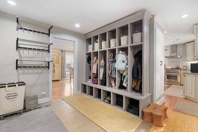 mudroom featuring light wood-type flooring, baseboards, and recessed lighting