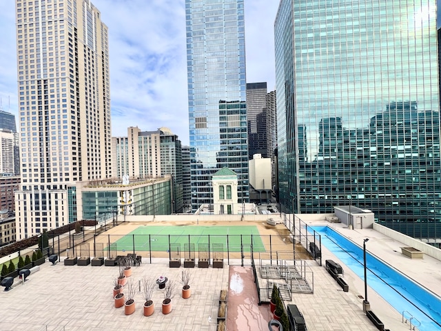 exterior space featuring a city view and fence