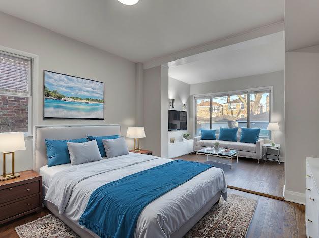 bedroom with wood finished floors and baseboards