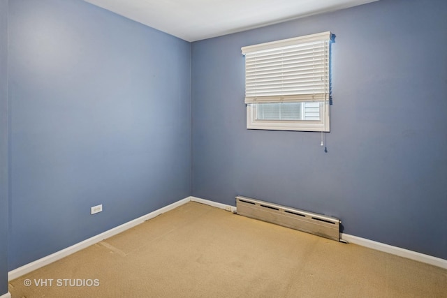 unfurnished room featuring carpet, a baseboard radiator, and baseboards