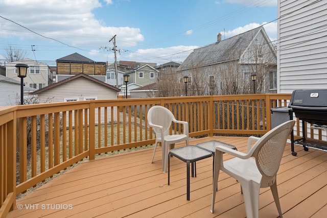 wooden deck featuring area for grilling