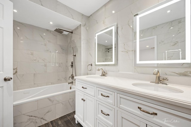 full bath with shower / bath combination, a sink, and double vanity