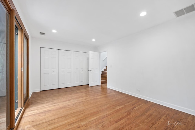 unfurnished bedroom with light wood finished floors, baseboards, visible vents, and recessed lighting