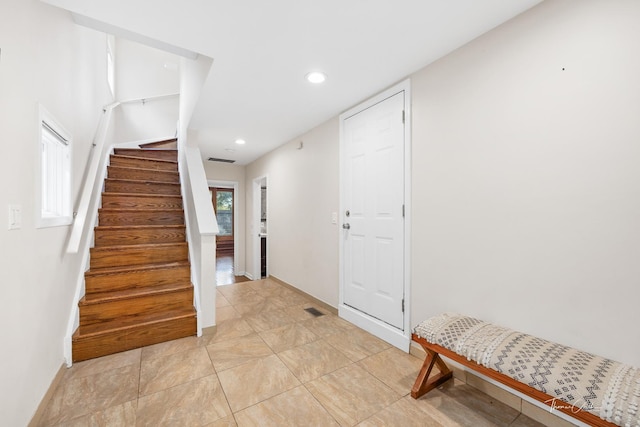 foyer with visible vents, stairway, and recessed lighting