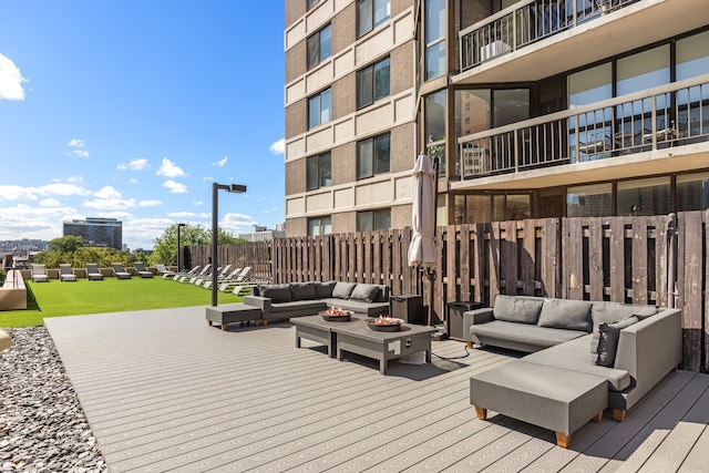 wooden terrace with a view of city and an outdoor living space with a fire pit